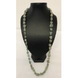 A strung necklace of natural green adventurine irregular shaped beads.