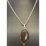 An oval silver pendant set with natural agate on a 22" chain.