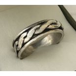 A men's silver spinner ring with Celtic knot design.