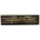 A vintage dark wood snooker score board with four metal sliding score pegs.