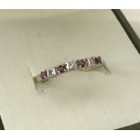 A 9ct gold ruby and diamond stone set half eternity ring.