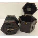 A vintage boxed 24 key Lachenal concertina with fretwork detail to speakers each end.