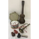 A box of assorted children's vintage musical instruments.