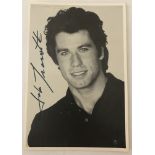 A signed black and white studio photo of John Travolta.