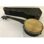 A vintage 4 string banjo with original case.