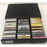A 3 drawer cassette tape cabinet containing a quantity of assorted 1980-90's tapes.