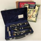 A hard cased Buffet Grampon & Co clarinet together with a small collection of music books.
