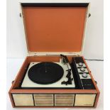 A retro Alba "Golden Disc" portable multi changer record player in orange, black and cream.