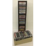 A large quantity of easy listening CD's together with a faux leather freestanding CD rack.