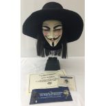 A "V" face mask and hat display film prop from the 2006 film V For Vendetta. Complete with 2 COA's.