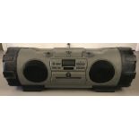 A vintage JVC Powered Woofer CD System Ghetto Blaster in grey & black.