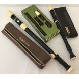 A cased Aulos Tenor recorder together with 2 Treble recorders.