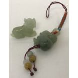 2 green jade carved robe charms of a monkey and a tiger.