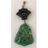 A mid 20th century Chinese jade and wood pendant.