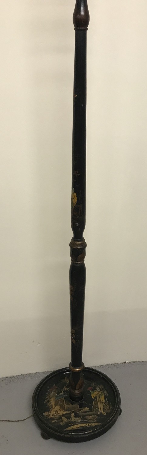 A Chinese black lacquer standard lamp with hand painted scene to base and detail to upright.