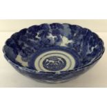 A blue and white ceramic bowl with blossoming tree decoration.