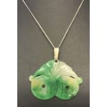 A green jade pendant with snake carved detail on a 18 inch fine silver curb chain.