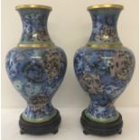 A pair of large cloisonné vases of bulbous form in blue tones with gold rims.