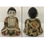 A ceramic sitting Buddha figure with gilt and hand painted floral decoration to his robe.