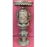 A late 19th century Meiji period Japanese 4 sectional bronze pedestal with decorative handles.