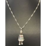 A white metal jointed clown pendant set with coloured stones on a 24 inch Singapore style chain.