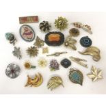 A collection of vintage brooches, some stone set.