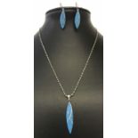 A contemporary design necklace and matching earrings set with turquoise.