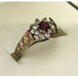 A 9ct gold garnet and white stone ladies dress ring.