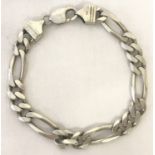 A silver Figaro chain bracelet with lobster clasp.