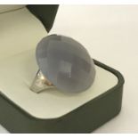 A large ladies cocktail ring set with faceted grey quartz.