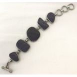 A modern design silver bracelet set with purple agate stones.