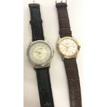 2 men's wristwatches. A Citron with silver face and black strap.