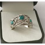 A modern design silver and turquoise dress ring marked 925.