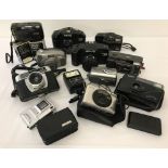A collection of vintage cameras and camera equipment to include Halina, Tamashi, Miranda and Canon.
