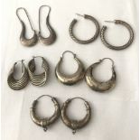 5 pairs of silver and white metal hoop and creole style earrings.