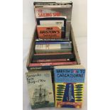 A box of books on boats and sailing.