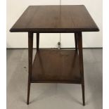 A vintage dark wood 2 tier occasional table with splayed legs.