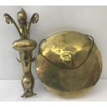 A decorative wall hanging brass gong with Art Nouveau style sconce.