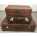 3 vintage brown leather effect suitcases.