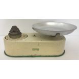 A vintage set of cream kitchen scales by Harper complete with dish and weights.