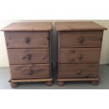 A pair of modern honey pine 3 drawer bedside cabinets on bun feet.