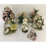 A box of Capodimonte ceramic floral spray ornaments in matte finish.