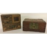 A vintage miniature chest of drawers with marquetry decoration.