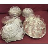 A collection of vintage glassware with 2 silver plated serving trays.