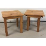 A pair of modern square topped pine side tables with screw on legs.