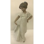 A Nao ceramic figurine of a girl holding her dress "How Pretty".