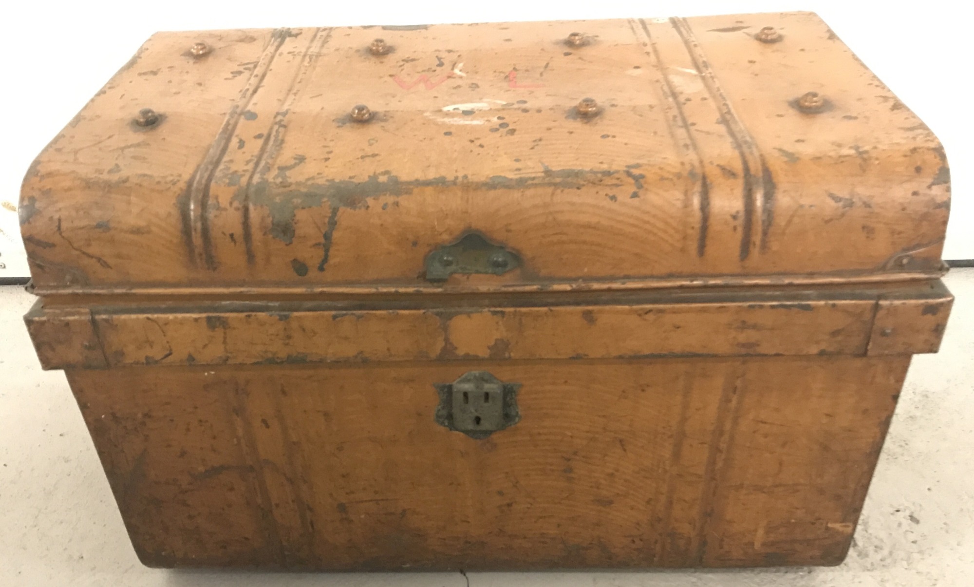 A vintage metal tin trunk with painted initials W.L. to top.