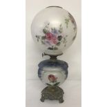 A vintage hand painted oil lamp with glass bowl and milk glass shade signed by Ticky Baniak.