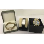 2 ladies wrist watches together with a men's modern steel strap wrist watch.