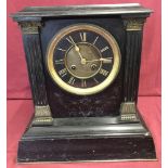A large vintage heavy slate mantel clock with column detail to front.